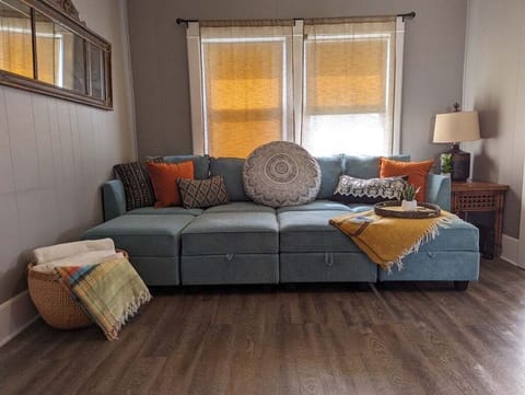 Sleeper sofa in living room (sleeps two). Bedding provided