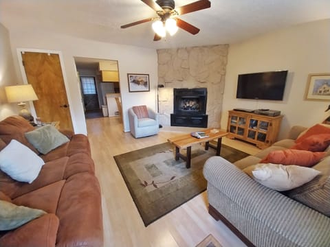 Settle into your spacious living room with cozy seating, a stone fireplace, and entertainment center—perfect for unwinding after your adventures.