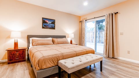 Huge master bedroom suite with one king size bed and a study desk.