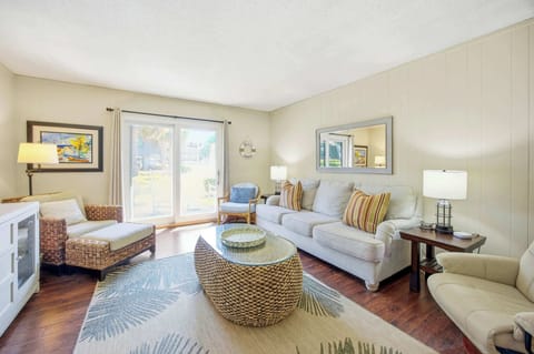 Bright living room with sliding glass doors and coastal-inspired decor.