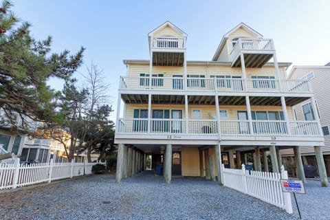 12 Dune Road - Tower Shores - Exterior Architecture - A front exterior view showcasing the classic coastal architecture, white balconies, and multi-level design of the property.