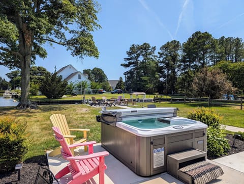 38166 Bow Street, Ocean View - hot Tub - Private outdoor oasis featuring a modern, multi-jet hot tub surrounded by professional landscaping and lawn space.