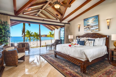 Master Bedroom with a king bed, vaulted ceilings, with panoramic ocean views of the white sands of Playa Flamingo