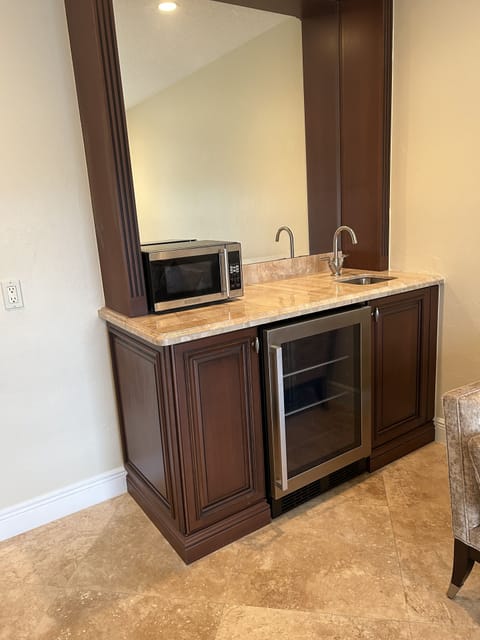 Wet bar in sitting room with microwave, Keurig & new (2023) mini fridge. 