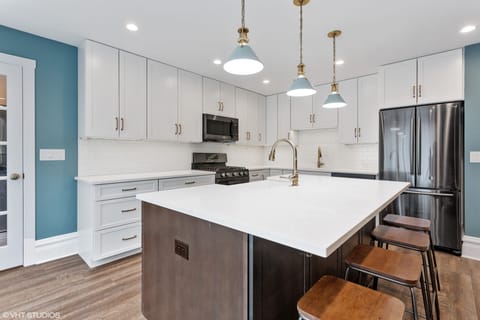 Kitchen nicely designed with Quartz countertops and Black Stainless Appliances

