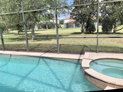 Pool & Spa with green space behind the house 