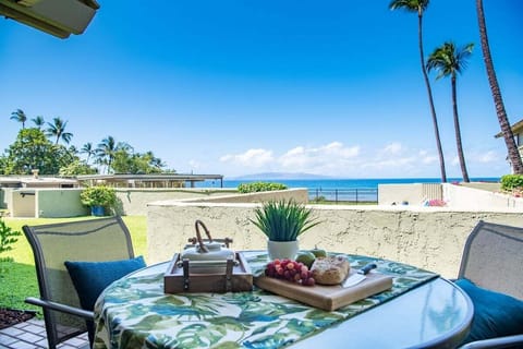 An outdoor patio set for tropical dining, where fruit, drinks, and ocean views make every meal unforgettable.