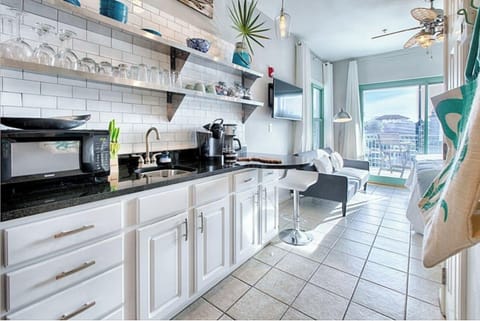 Your modern kitchen features granite counters, white subway tile, and city views for culinary adventures.