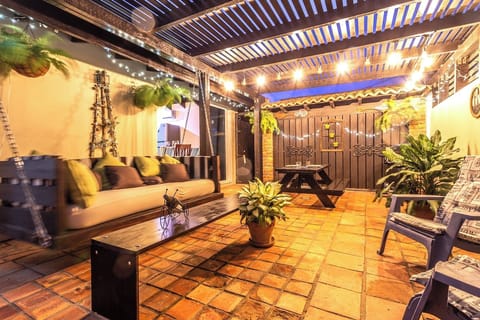 Pleasant outdoor seating area of the Apartment in Noord Aruba - Well-chosen lighting fixtures adding both functionality and charm - Cozy seating area conducive to relaxation and socializing