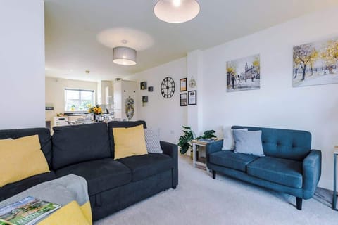 Open plan living room benefiting from a large double sofa bed and Smart TV.
