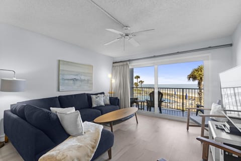 Bright living room with ocean views and cozy seating