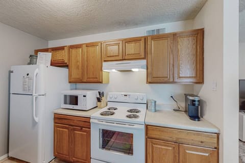 Kitchen includes simple set of spices, Keurig with k-cups, and enough utensils and cooking ware for a simple meal.