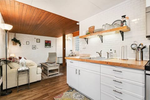 Morning light spills across the open living-kitchen space—your first cup of coffee at the butcher-block counter, soft couch waiting for lazy conversations, and the whole day ahead to simply be together. This is where slow weekends and cozy reunions begin.