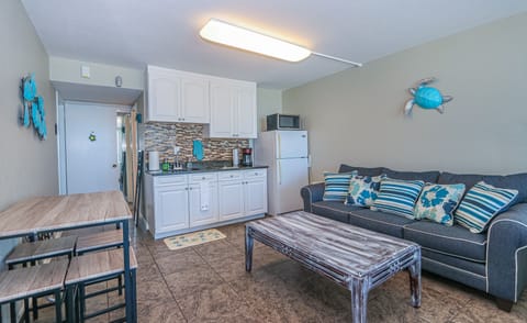 Full size fridge and hot plate with cooking supplies 