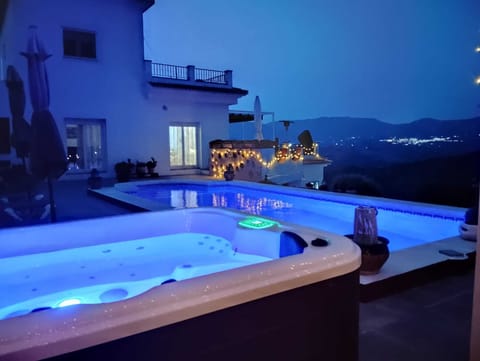 Jacuzzi and Pool at nightime