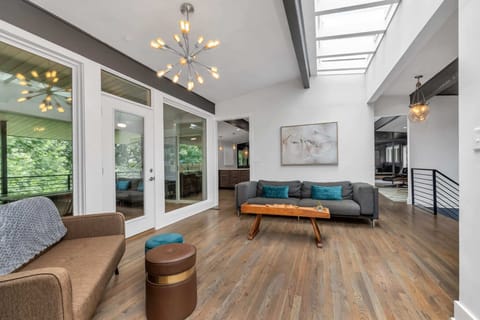 Entry Way -  Opens up to one of the home's three living areas. A large skylight above the beams draws in ample natural light.