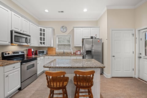 The kitchen island provides additional counter space for serving snacks or meals