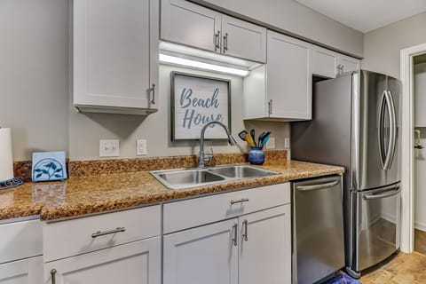 Fully Equipped Luxury Kitchen with Stainless Steel Appliances and Updated White Cabinetry