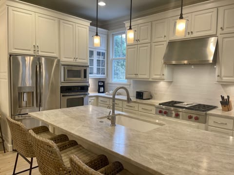 Recently remodeled kitchen with Wolf gas cooktop and new countertops