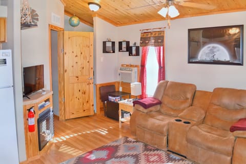 Living room w/ duel recliner love seat, electric fireplace & Smart TV