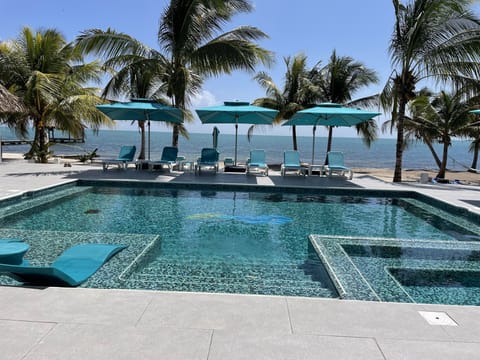 The view out the front doors of the villa.  14 lounge chairs & 7 large umbrellas