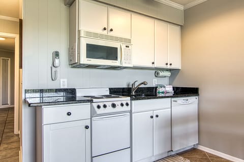 The updated kitchen has stone countertops.