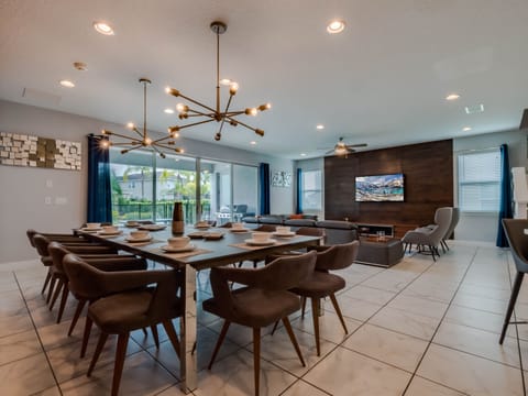 - Dining area with seating for large family meals  
- Modern living room with flat screen and cozy sofa  
- Open floor plan connecting kitchen, dining and lounge