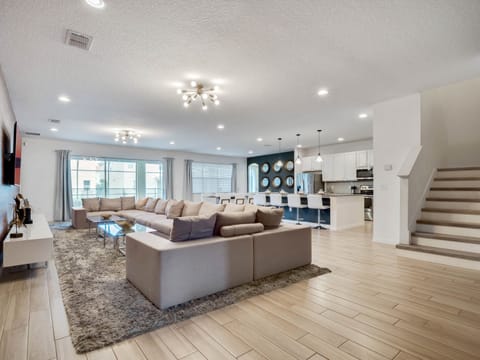 - Spacious living room with sectional seating for the whole group  
- Open layout flows into modern kitchen and large dining table  
- Relax in comfort with streaming ready flat screen TV setup