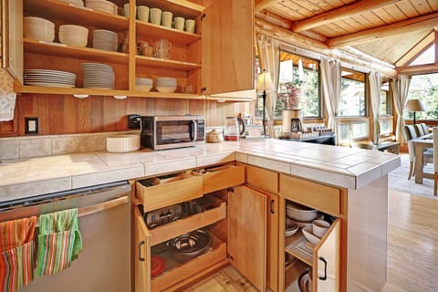 Fully stocked kitchen. Lots of dishes and serving platters