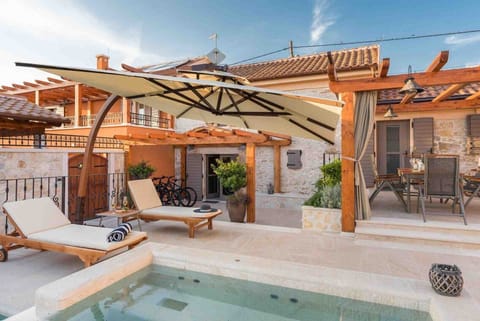 Deck chairs by the pool of a Croatian luxury vacation villa with concierge service and private parking in Skradin