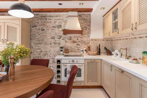 Dining table and kitchen on the ground floor of a luxury family villa with heated pool and wifi
