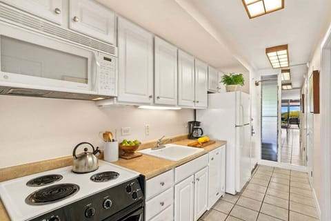 Functional kitchen with white appliance and cabinets