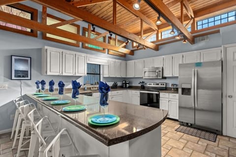 Spacious kitchen - fully-stocked & well-appointed for your stay. Stainless steel appliances and breakfast bar seats 6.