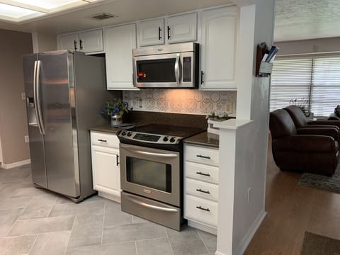 Range wall side of the kitchen with dishes and pots & pans.