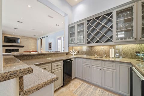 Wet bar attached to living room and billiard room