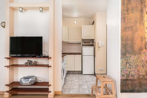 Compact kitchen with all essential appliances, including a washing machine and microwave for convenience.