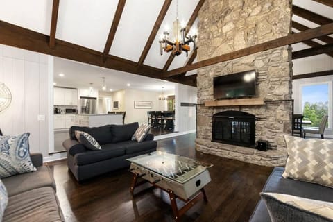 Comfy living room atmosphere with mini foosball table, tv and large comfortable couches