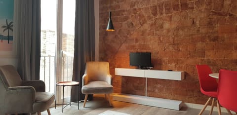 Exposed historic brickwork meets modern design in this sunlit living space. Relax in the cozy seating area before heading out to explore.