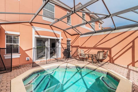 Step outside to relax in your private pool area, surrounded by a vibrant orange wall that enhances the sunny atmosphere. Comfortable seating invites you to unwind while the gentle water beckons for a refreshing dip.
