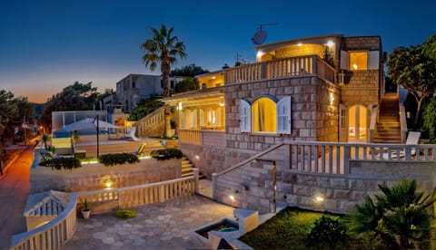 Night picture of the property of family luxury villa Stone Castle in Selca with private heated pool for vacation and rent