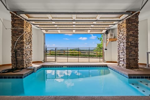 Heated indoor pool w/garage door which can be opened on warm days.