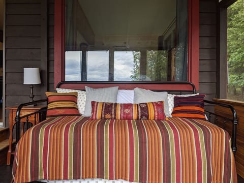 A daybed (just outside the queen room's window) on the screened-in porch. Linens are provided if you want to sleep there. 