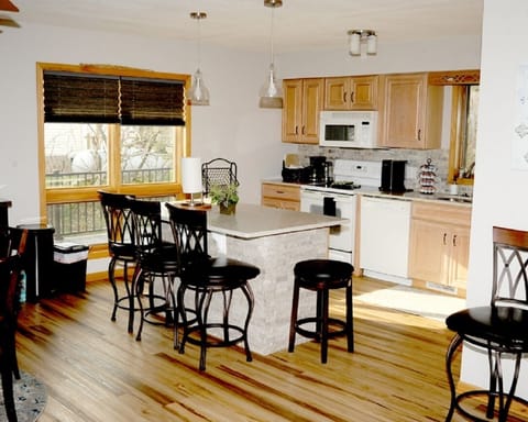 kitchen equipped with an island and dining room table equipped and fully stocked