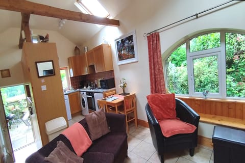 Living Room with front door on left and garden view