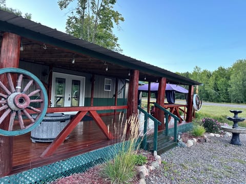 Large covered deck with various seating and patio gas fire pit.  Screen tent too
