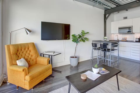 Living Room / Kitchen, featuring a laptop stand/ end table.