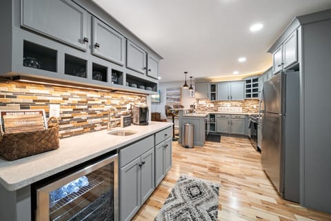 Open-concept kitchen and wet bar stocked with tea, coffee, and water!