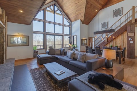 Impressive living area with vaulted ceilings and stone fireplace