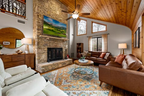 Living Room With 75" HDTV and Wood Fireplace