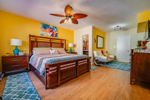 Master bedroom, with view to master bath and door to private laundry